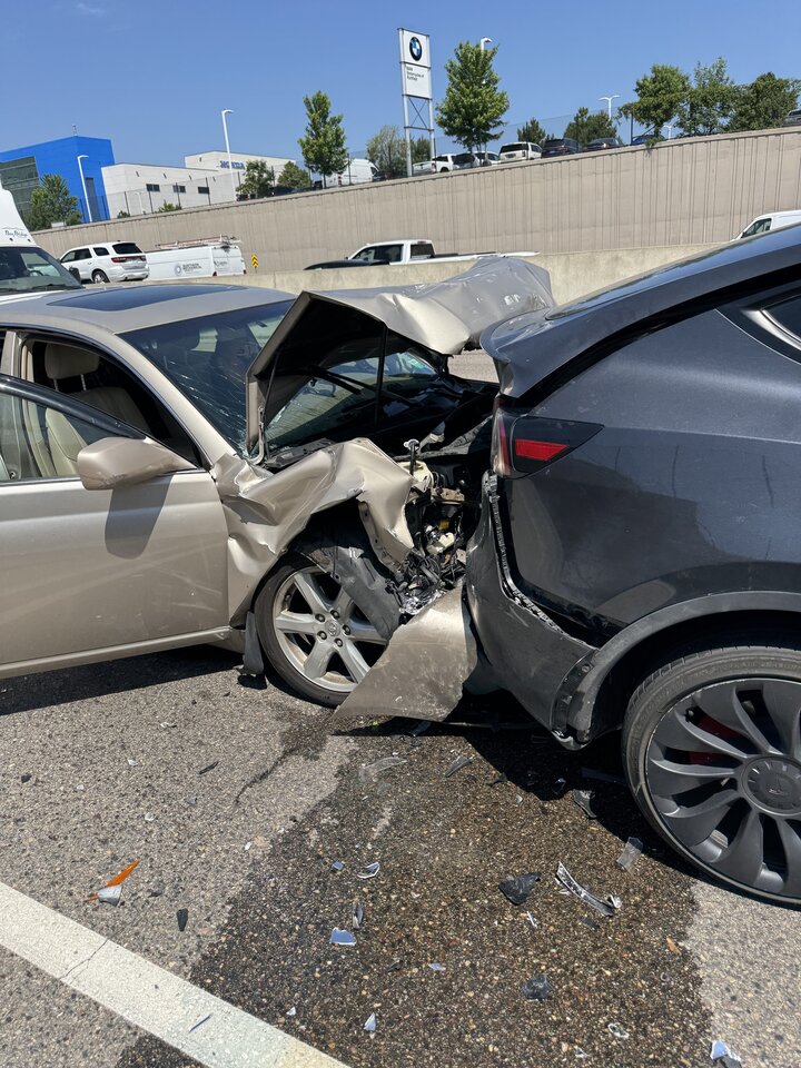 Front-end damage to a sedan and rear-end damage to an SUV after the collision.