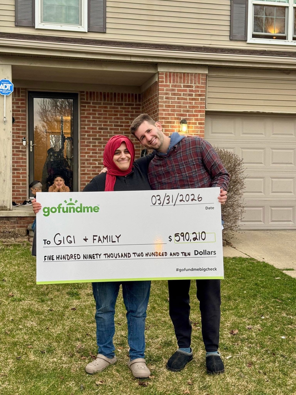 Josh Liljenquist with Azeza, Gigi's family, and a GoFundMe check