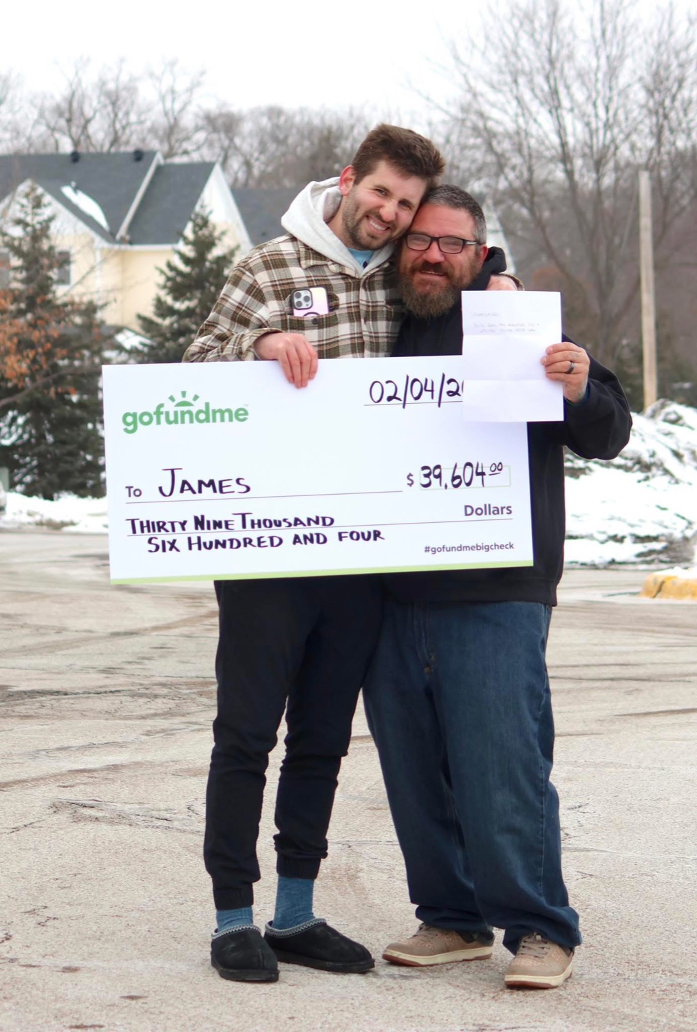 Josh Liljenquist with James and a GoFundMe check