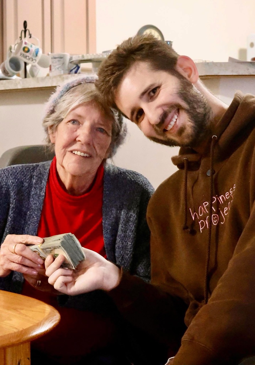 Josh Liljenquist sitting with Shirley after giving her fundraiser support
