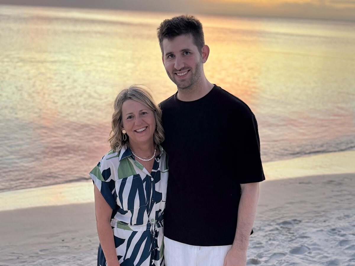 Josh Liljenquist with his mother, Julie Ann Liljenquist, together on a beach at sunset.