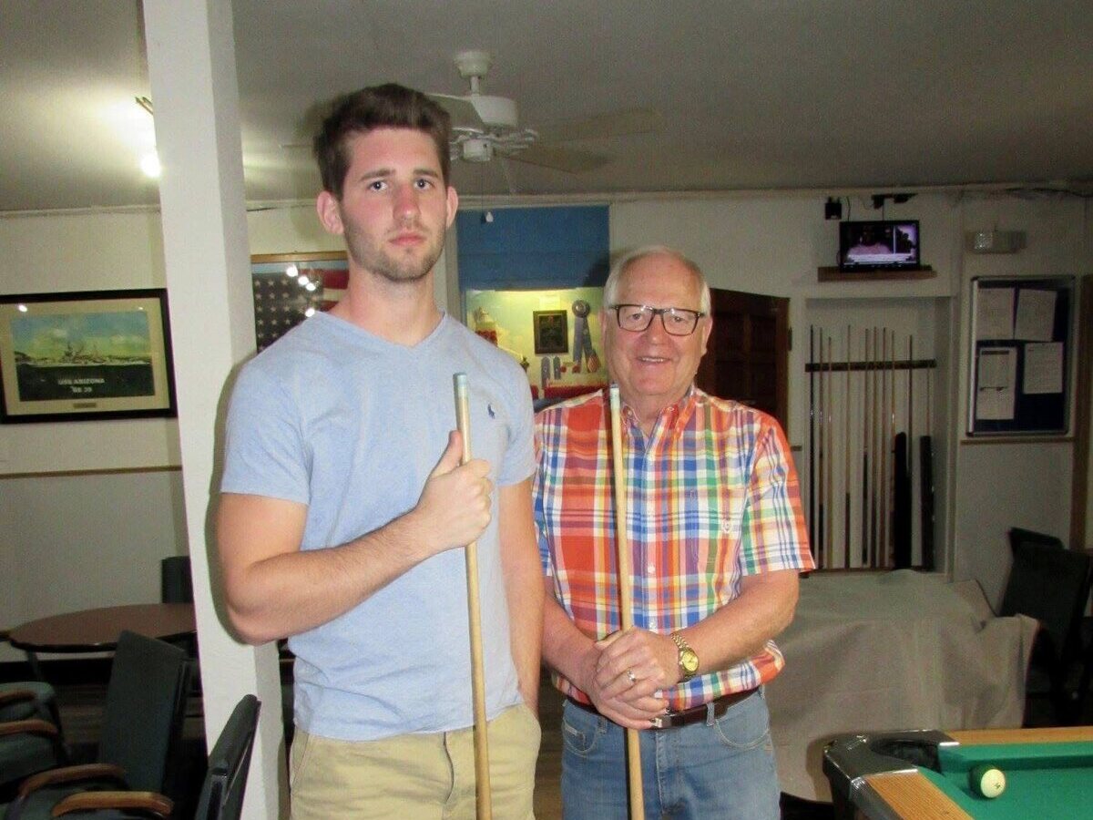 Josh Liljenquist with his grandfather Thomas Emmett Westcott Jr. holding pool cues.