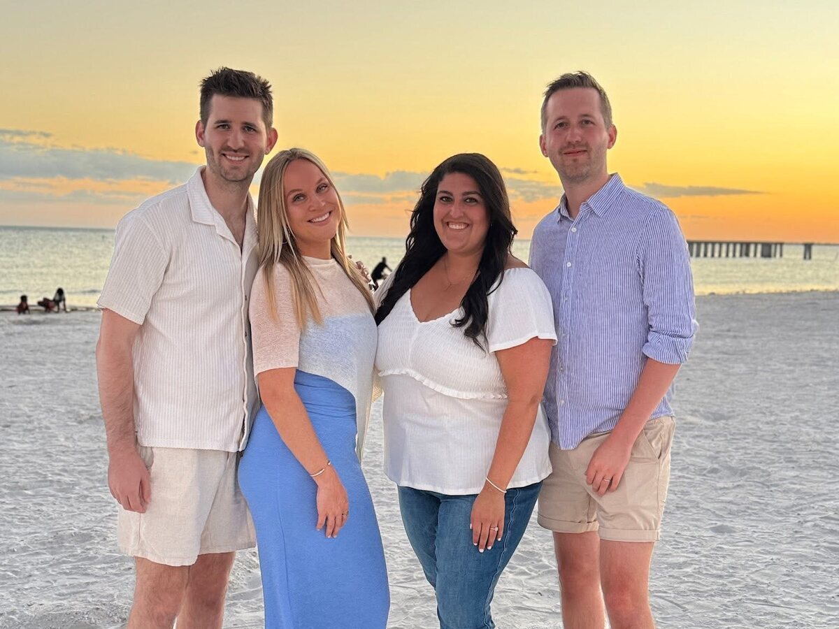 Josh and Ingrid Liljenquist with Jacob and Lauren Liljenquist together on a beach at sunset.