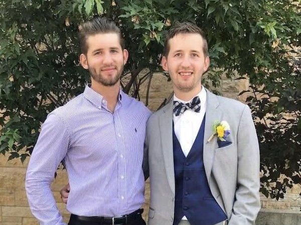 Josh Liljenquist standing with his brother Jacob Liljenquist outdoors at a formal event.