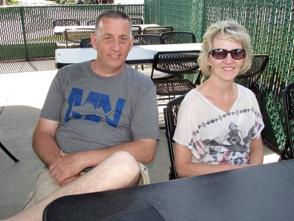 Thomas Calvin Eckdahl and Tracy Eckdahl seated together outdoors at a family gathering.