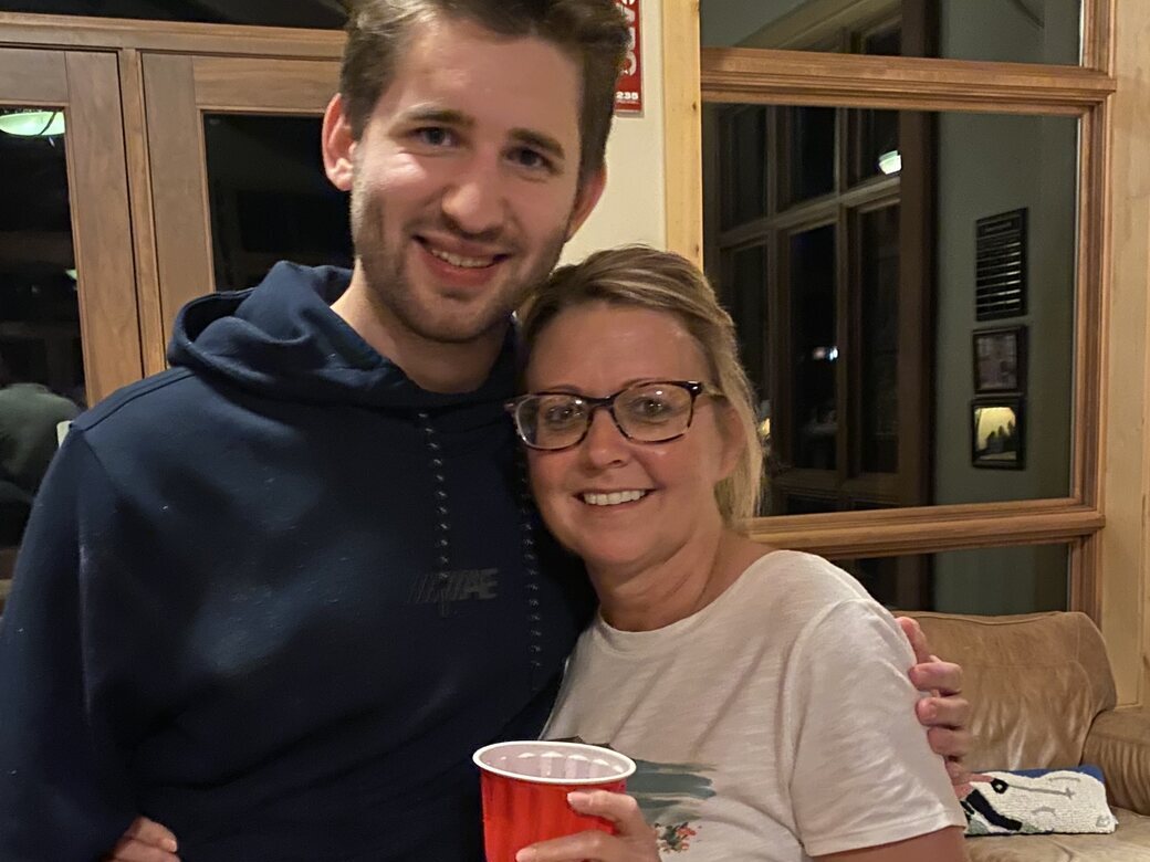 Josh Liljenquist with his aunt Carrie Westcott during an indoor family gathering.