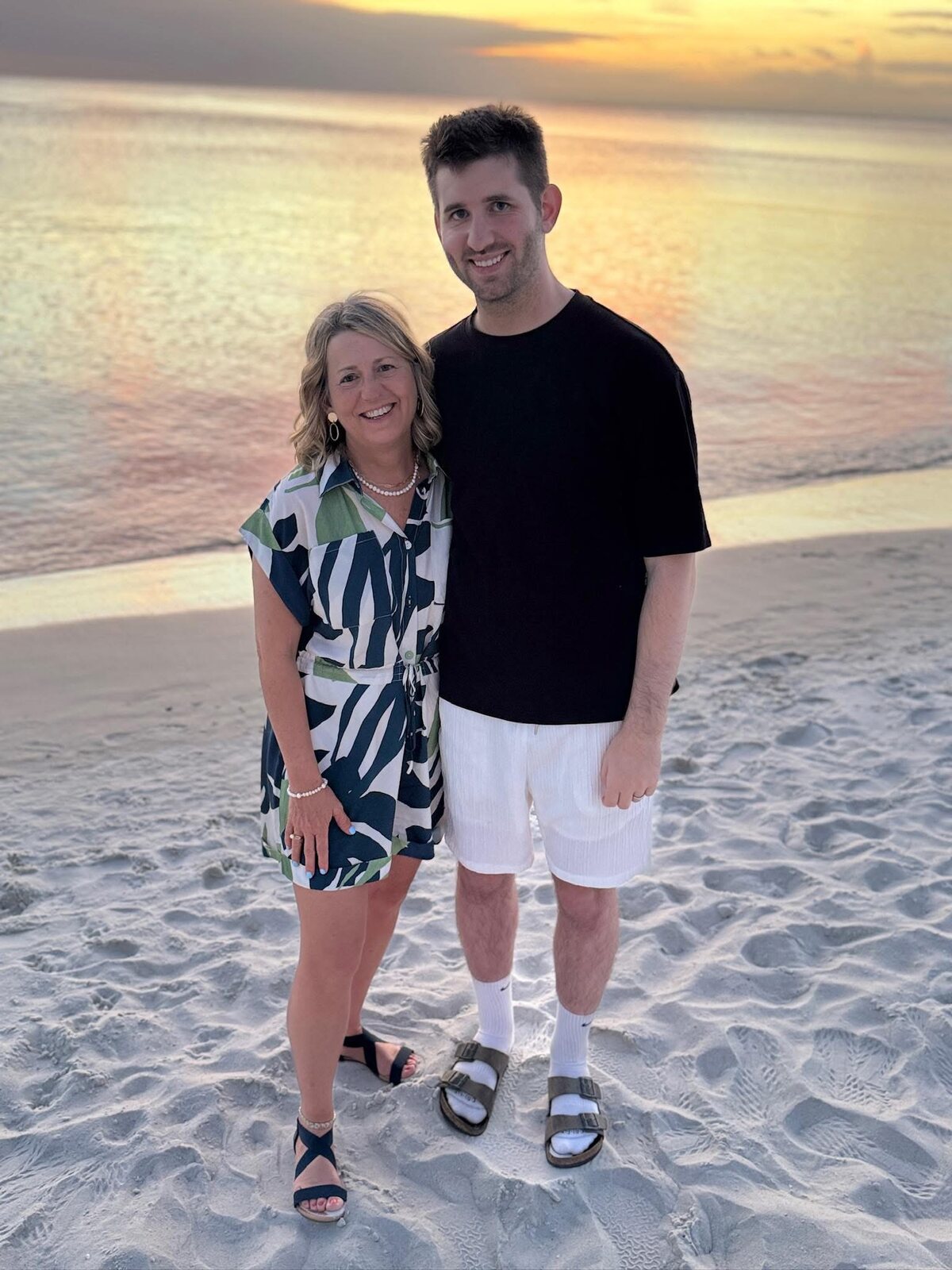 Josh Liljenquist with his mother, Julie Ann Liljenquist, together on a beach at sunset.