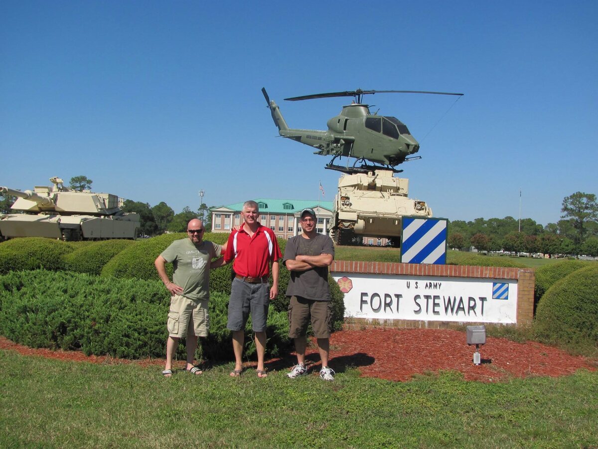 Trent Liljenquist at Fort Stewart, Georgia, with military vehicles and displays in the background.