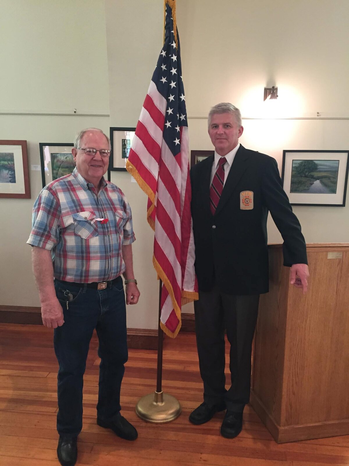 Trent Lee Liljenquist and Thomas Emmett Westcott Jr. standing beside an American flag.