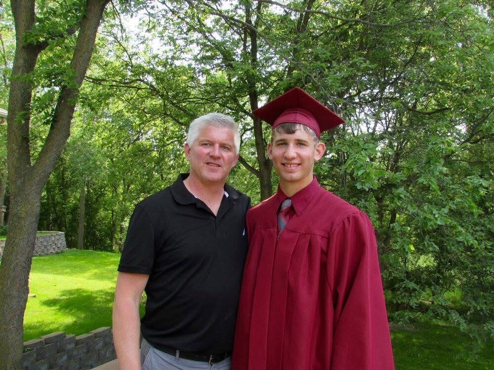 Josh Liljenquist in cap and gown with his father, Trent Lee Liljenquist, at Josh's graduation.