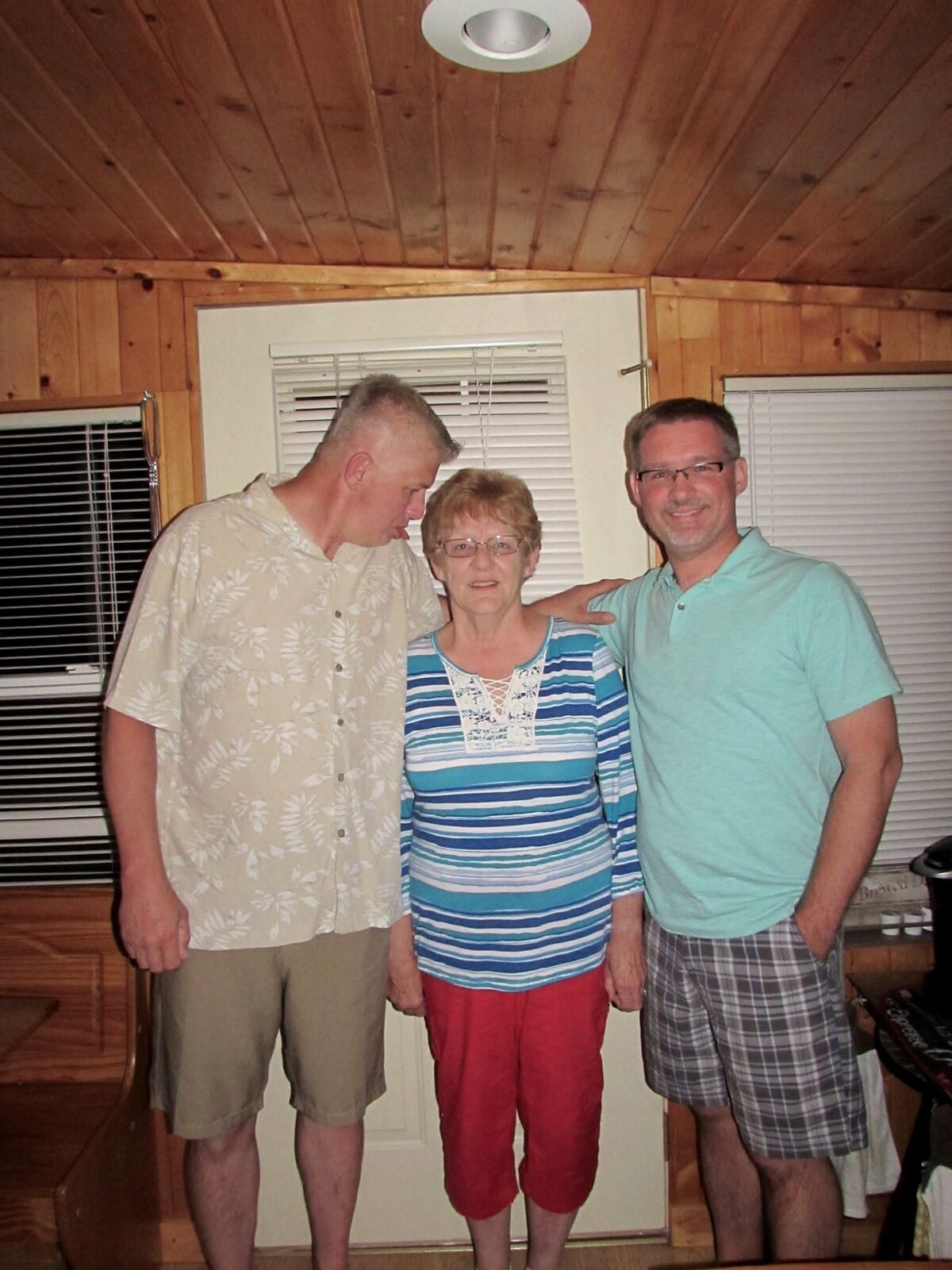 Corrine Liljenquist with her sons Trent and Todd Liljenquist joking together during a family gathering.