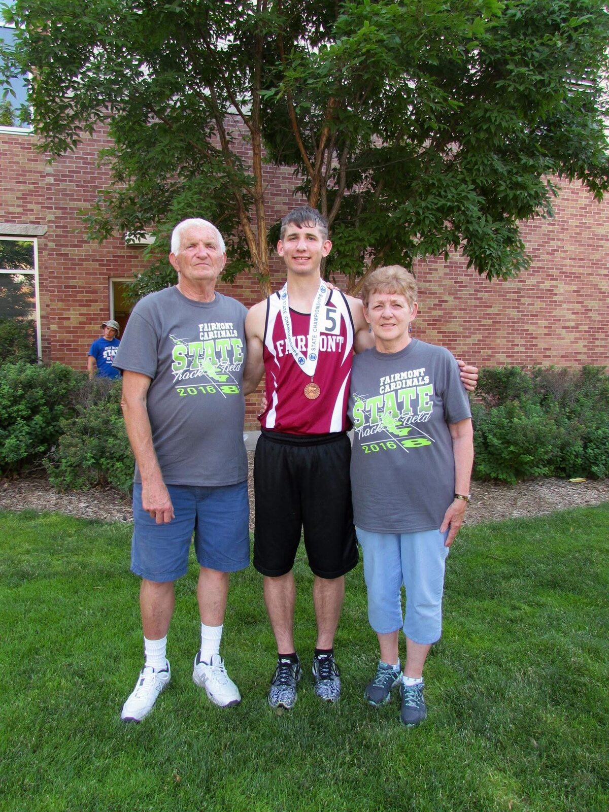 Josh Liljenquist with his grandparents Lee and Corrine after a 2016 state track and field event.