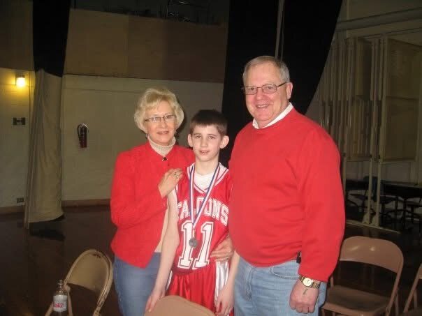 A young Josh Liljenquist in a Fairmont basketball uniform with his maternal grandparents Mary and Tom Westcott.