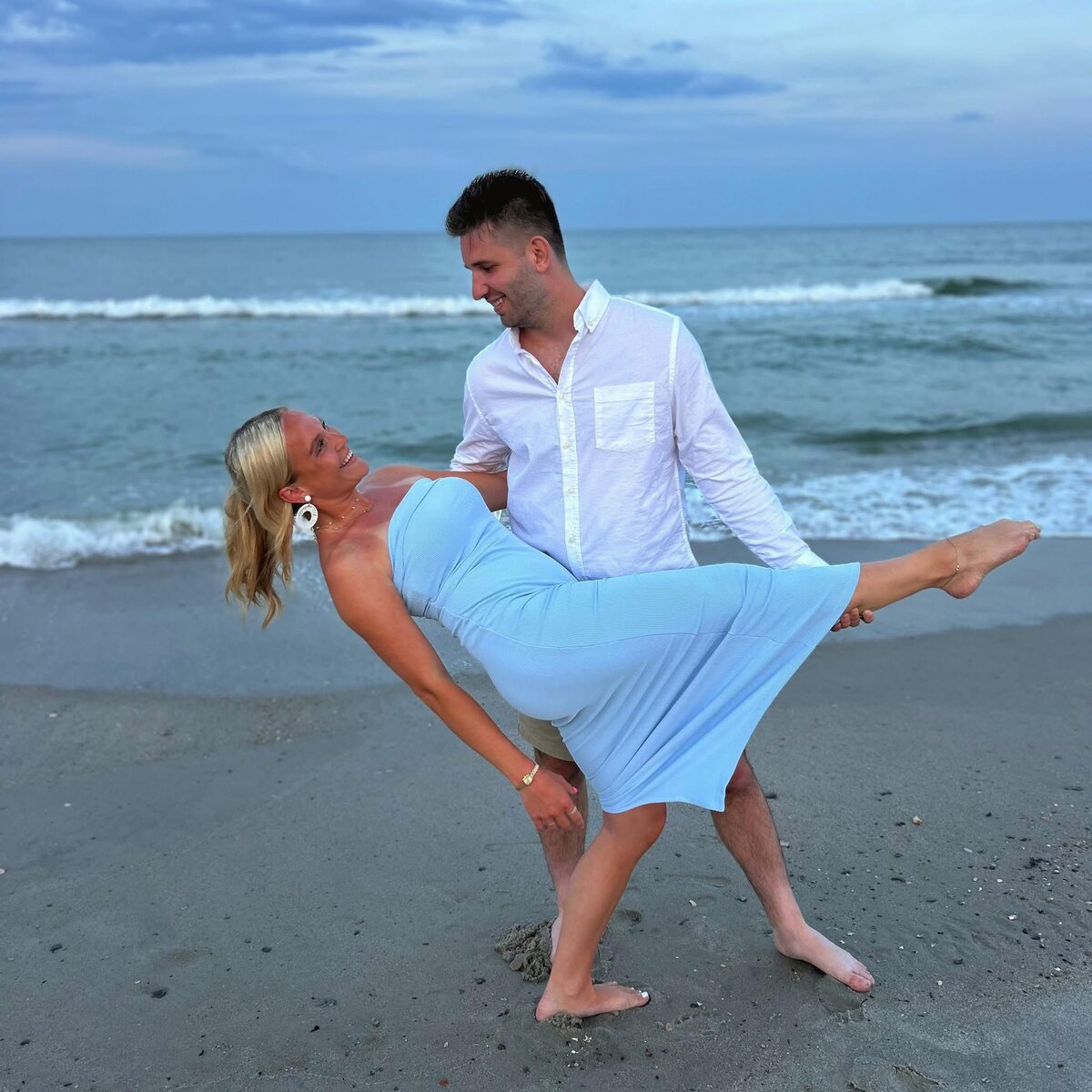 Josh and Ingrid sharing a playful moment on a beach, reflecting the humor Josh says is central to their relationship.