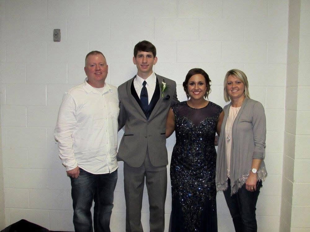 Josh Liljenquist with Carrie and Mark Westcott at a formal indoor family event.