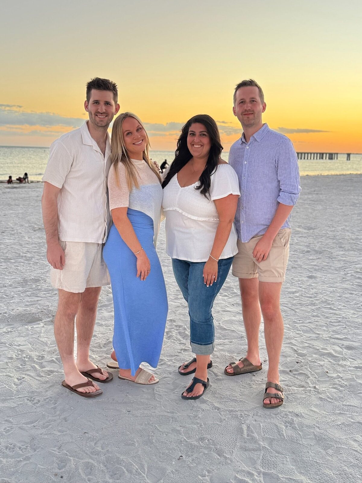 Josh and Ingrid Liljenquist with Jacob and Lauren Liljenquist together on a beach at sunset.