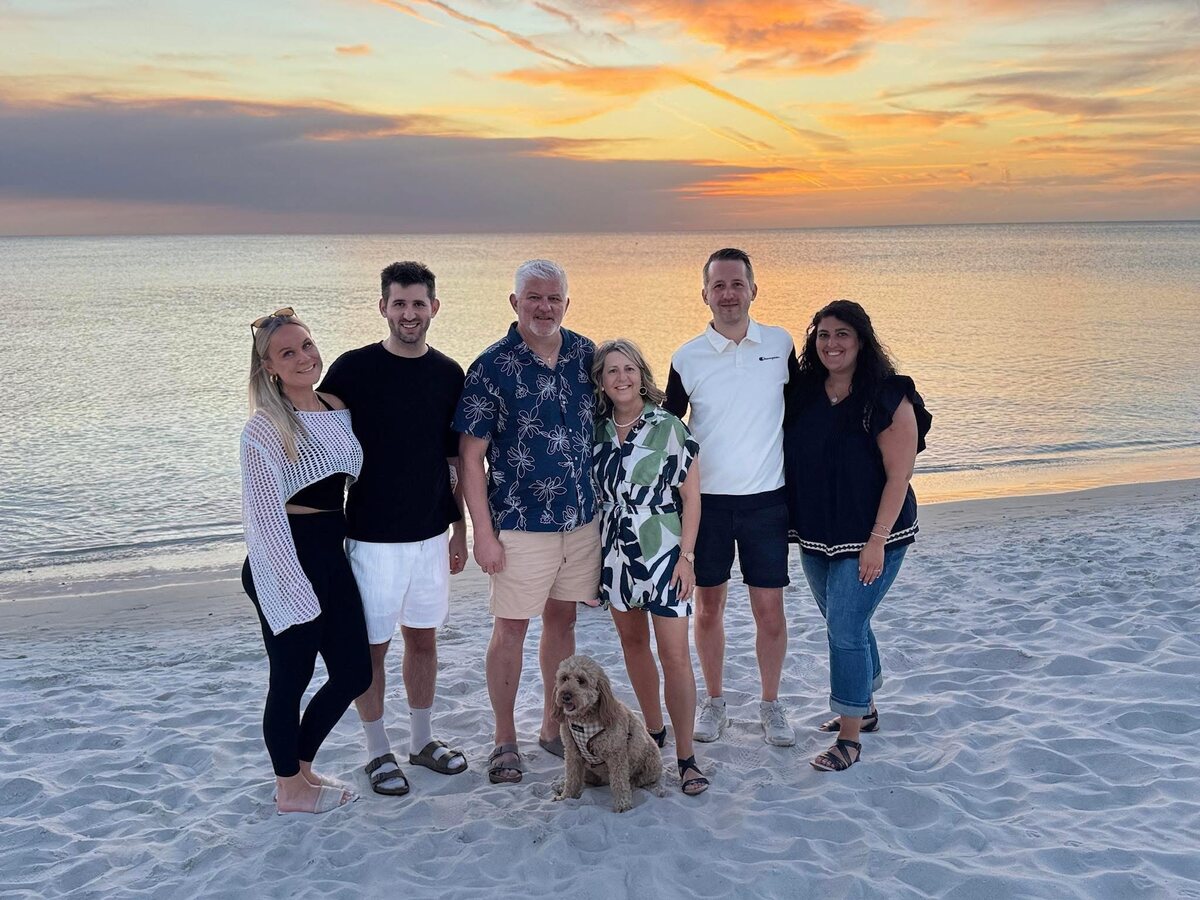 Josh and Ingrid Liljenquist with Trent and Julie Liljenquist, Jacob Liljenquist and Lauren Liljenquist on a beach at sunset.