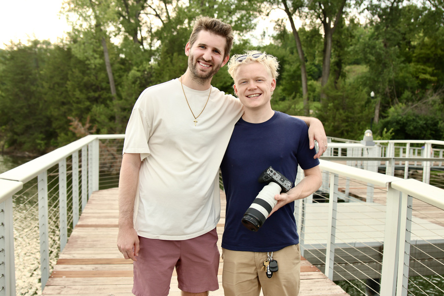 Josh Liljenquist posing with videographer Ben Steine, who is holding a camera