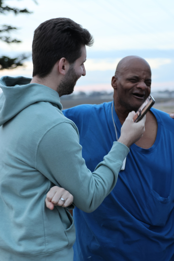 Josh Liljenquist holding a microphone while speaking with an unnamed man in Fairmont, Minnesota