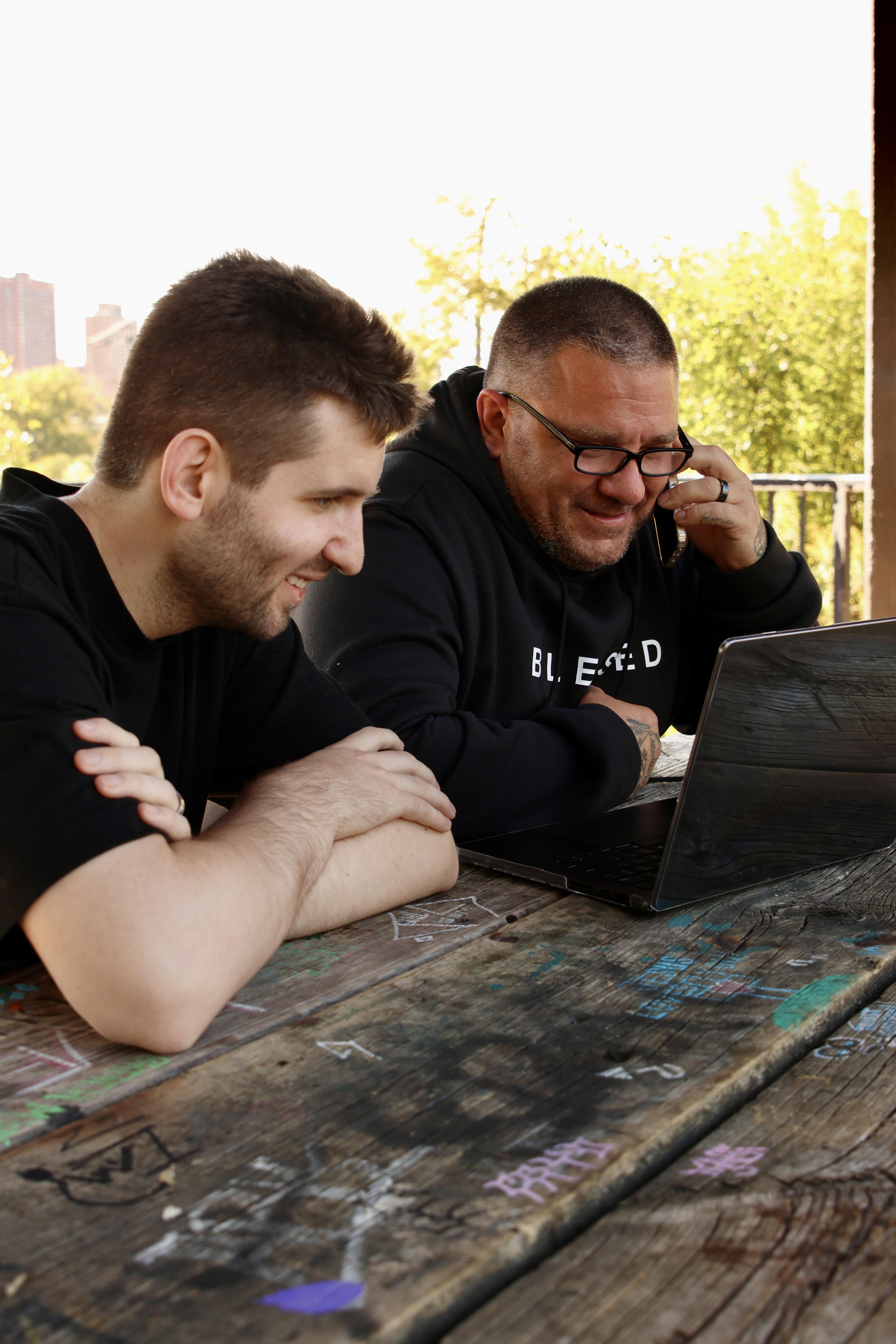 Josh Liljenquist and James Cowan Jr. reviewing community nominations at a laptop in Minneapolis