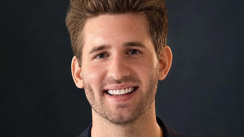 Professional headshot of Josh Liljenquist, known online as JoshLilj, wearing a navy blazer