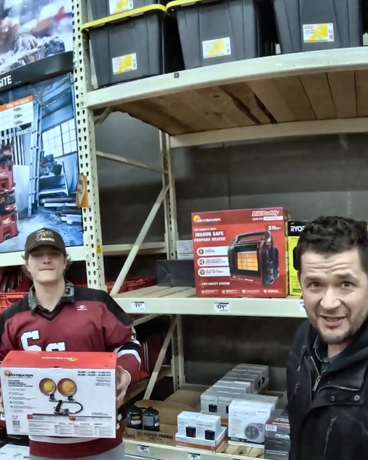 Josh Liljenquist and two collaborators selecting boxed heaters during a community supply purchase