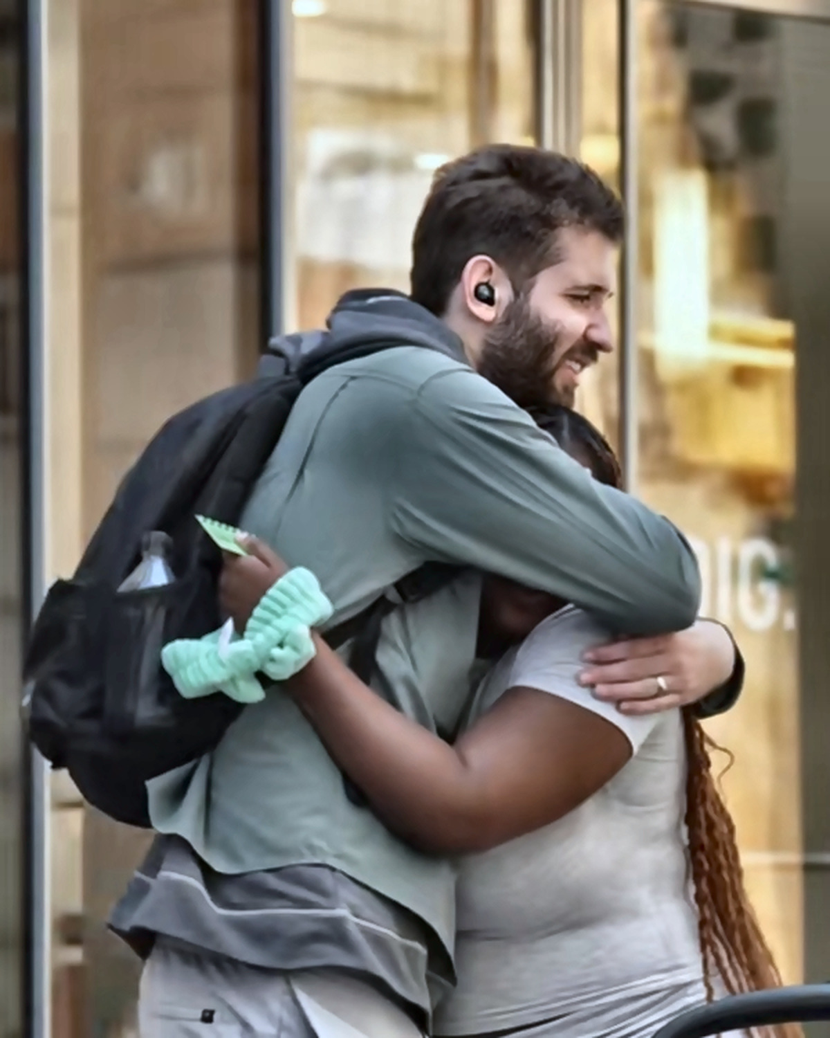 Josh Liljenquist embracing a parent beside a stroller during a family-support story