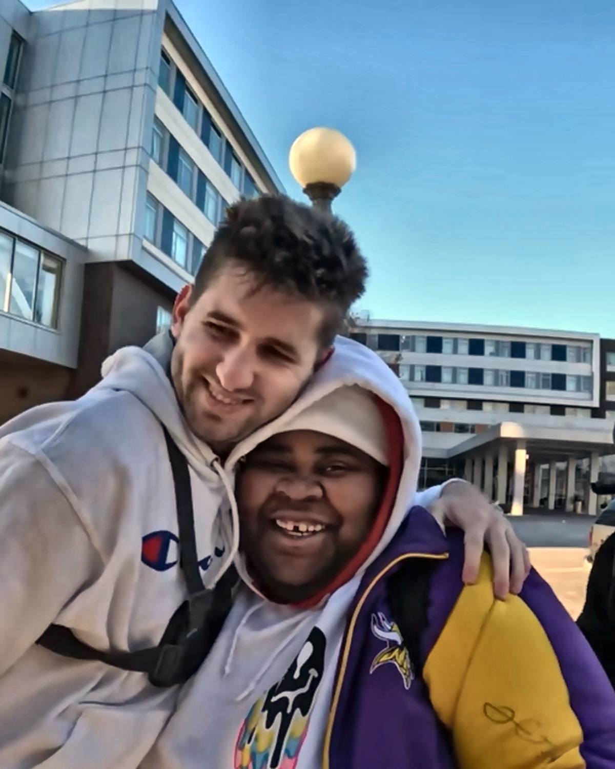 Josh Liljenquist smiling with a community participant during an outdoor outreach event