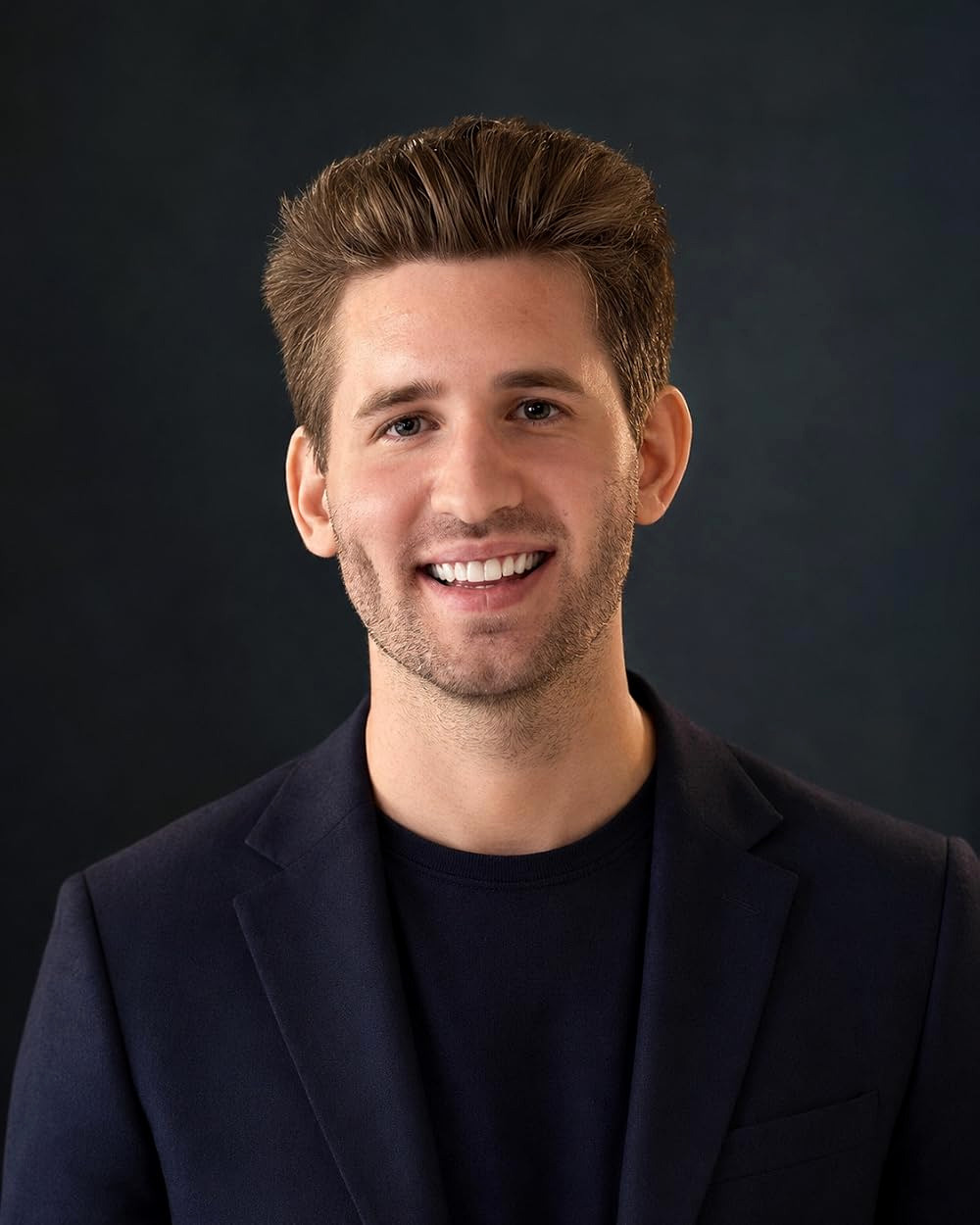 Professional headshot of Josh Liljenquist, known online as JoshLilj, wearing a navy blazer